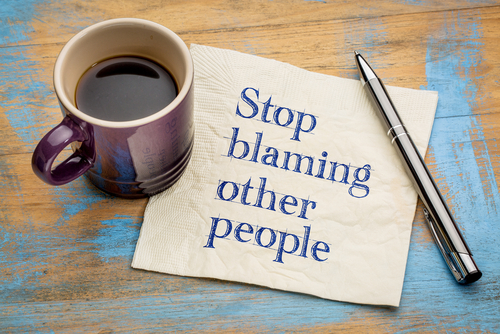 Meme: Stop blaming other people, on lined paper with coffee mug and pen