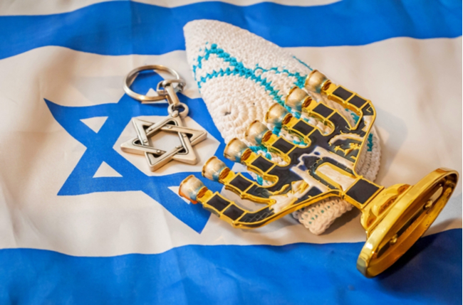 Israeli flag juxtaposed with Jewish items to illustrate that Israel is the Jewish State
