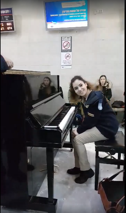 Israeli female soldier plays piano in train station